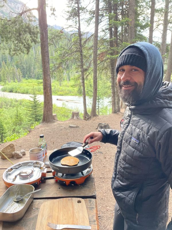 Mike Making Breakfast While Camping in Wyoming