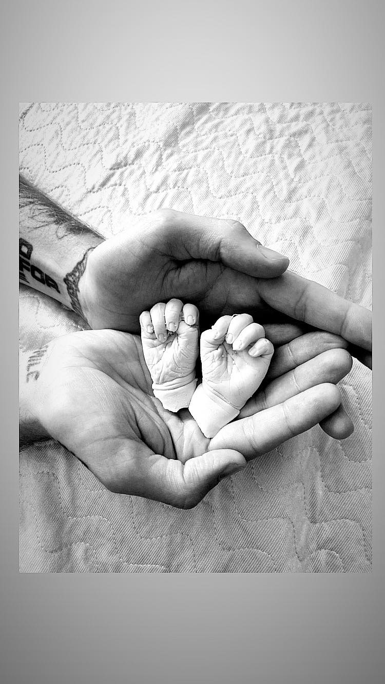 Brandon Holding Hand Casts From Our Daughter, Fern